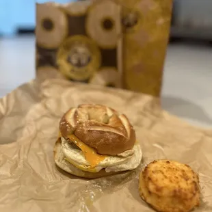 Turkey sausage and cheddar egg sandwich on a pretzel bagel with hash browns.