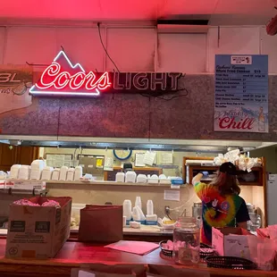 a neon sign above the counter