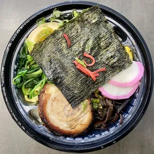 Spicy miso ramen in take-out plastic container