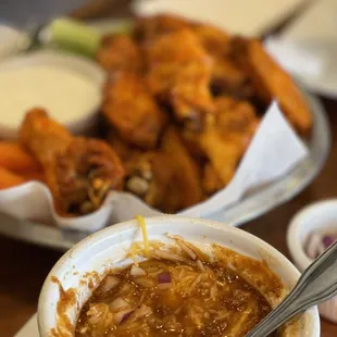 a bowl of soup and a plate of wings