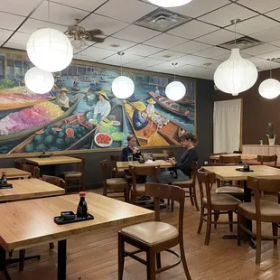 a woman sitting at a table in a restaurant