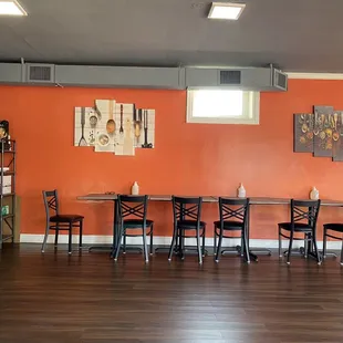 a dining room with orange walls
