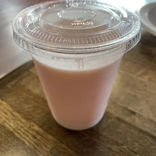 a plastic cup of yogurt