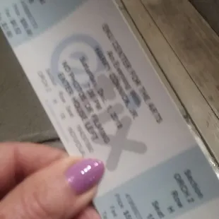 a hand holding a ticket
