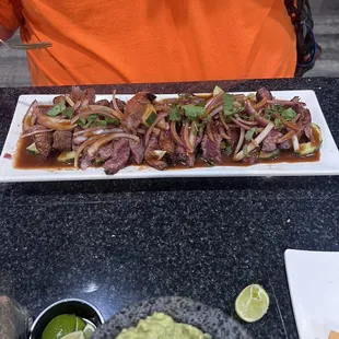 He doesn&apos;t remember what he ordered but it was a delicious beef dish cooked rare with onions.