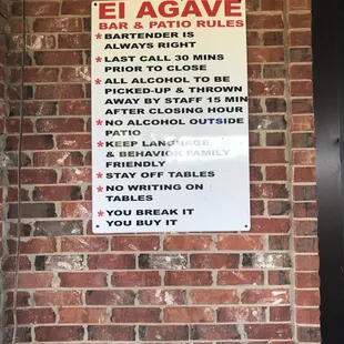 a sign on a brick wall