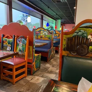 a restaurant with colorful booths and tables