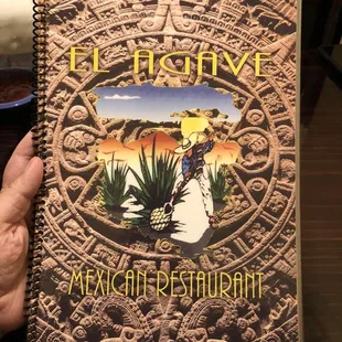 a hand holding a mexican restaurant book