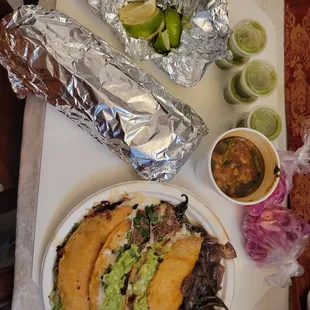 Massive burrito, quesabirrias, consome, limes, salsa, onions