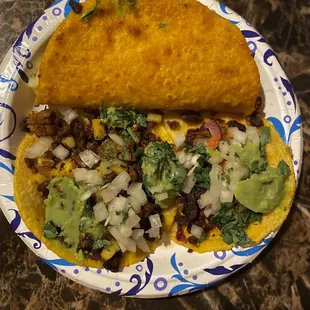 Quesabirria, pastor and chorizo tacos. The meat on the tacos was crunchy, burnt.