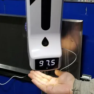 Automated hand sanitizer station that also checks your temperature -- so cool!