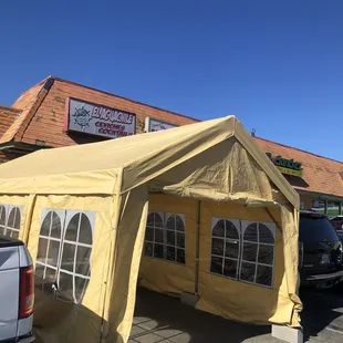 a yellow tent in a parking lot