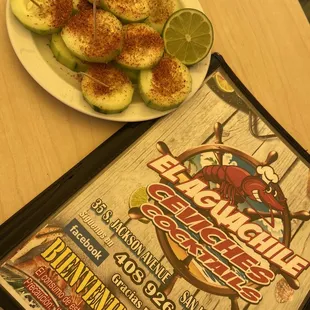 a plate of cucumbers and a menu