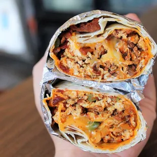 a hand holding a burrito