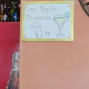 a sign on the wall of a bar