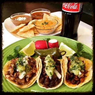 Taco de carnitas (pork),  asada (grilled steak) &amp; adobada (marinated pork) with sides of arroz, frijoles, chips &amp; salsa.