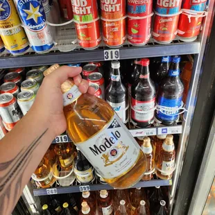 a hand holding a bottle of alcohol