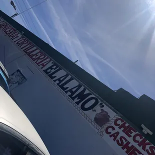 a white car parked in front of a building