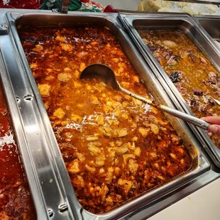a person serving food at a buffet