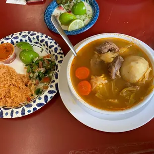 a bowl of soup and a plate of rice and vegetables