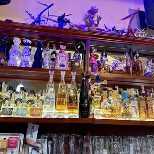 a shelf full of liquor bottles