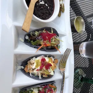 Steak, chicken, and al pastor tacos with black beans and cactus salad