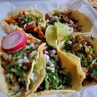 Tacos de barbacoa, carnitas, chicken and mole, suadero, and beef.