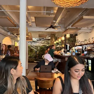 two women sitting at a table in a restaurant