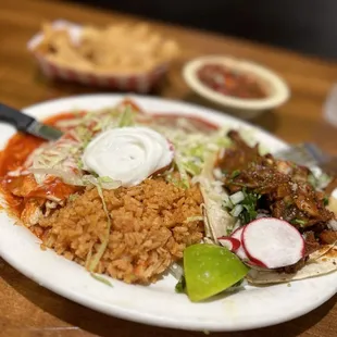 Chicken enchilada, and Pastor taco with rice and beans.