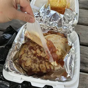 a person holding a sandwich