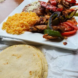 Chicken fajitas. Plenty of yummy veggies: Red and green peppers, onions, tomatoes.