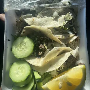 a plastic container with a variety of food items