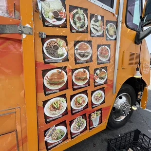a food truck with plates of food on it