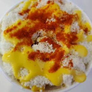 a closeup of a bowl of rice topped with mango sauce