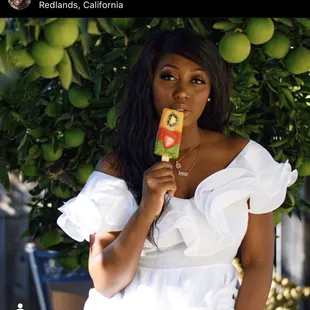 a woman eating a popsicle