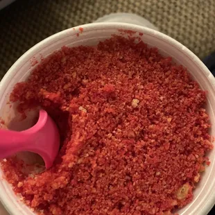 a person holding a cup of red food