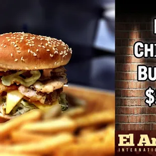 a picture of a big chicken burger with fries