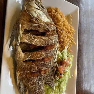 a plate of fish and rice