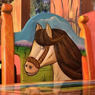 a horse painted on a chair