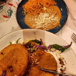 GORDITAS (2) Two corn-based dough chorizo, lettuce, shredded cheese, tomato, and light beans. Served with rice and beans. $ I4.99