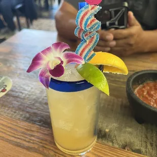 a drink with a flower garnish