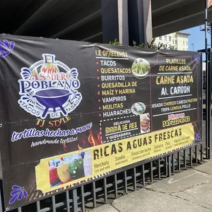 Signage in front of area where food truck parked.