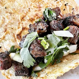 a taco with meat and vegetables