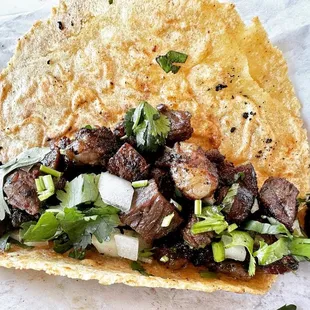 a taco with meat and onions