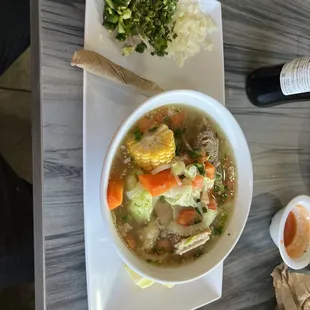 a bowl of soup and a bottle of wine