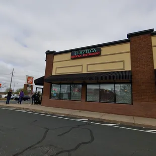 people walking in front of a restaurant