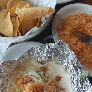 Chicken taco, rice, tortilla chips and enchiladas