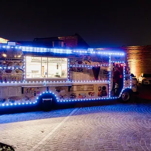 a food truck decorated with christmas lights