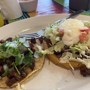 Pictured one asada taco and an asada sope.