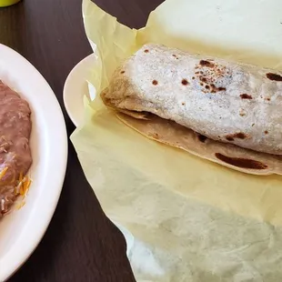 Breakfast burrito (sausage, potato, egg and cheese), side of refried beans.